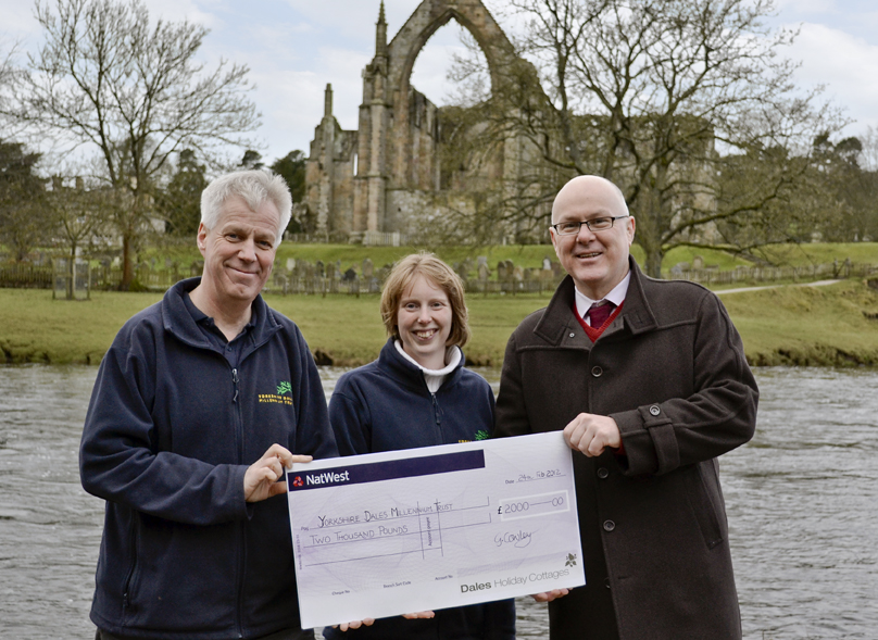 Geoff Cowley presents a cheque for £2,000 to YDMT Director David Sharrod