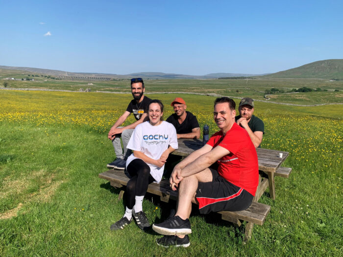 DARE group pausing for a break in a flowery field